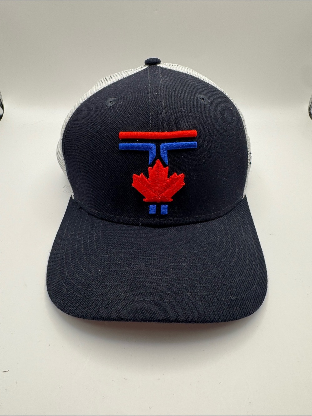 Men's Navy Trucker Hat with Red Maple Leaf Accent